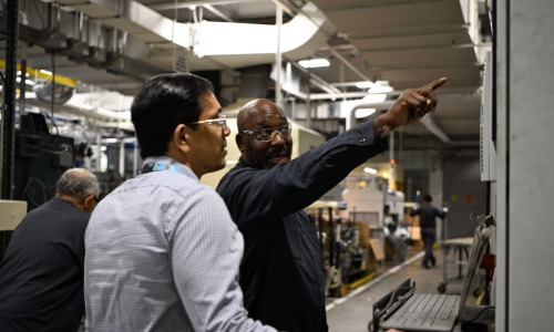 two team members discussing and pointing at equipment